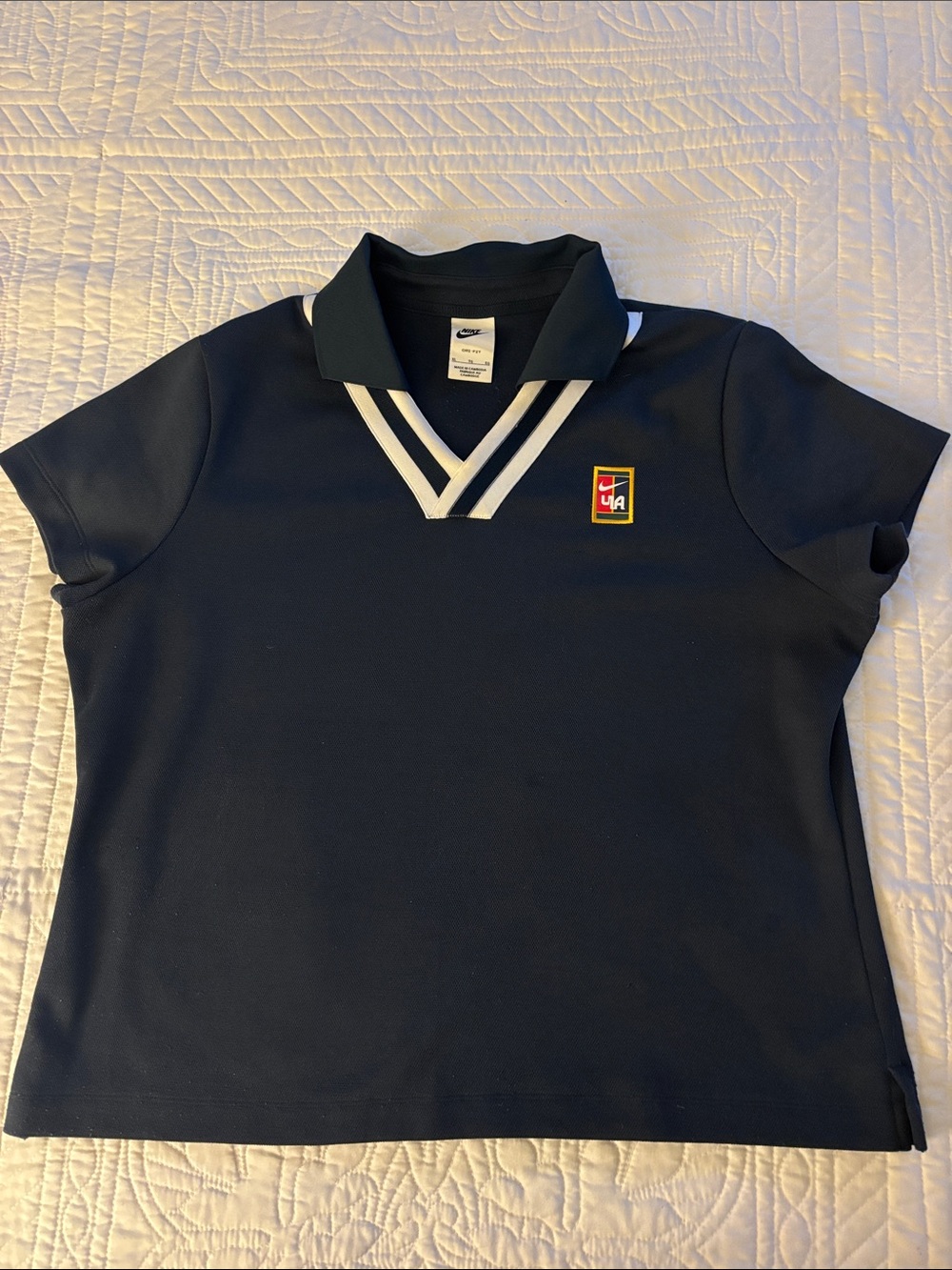 Nike Navy Polo with White V-Neck Stripes and Crest Logo